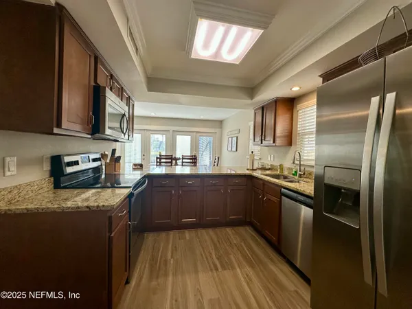 a living room with furniture a flat screen tv and a table