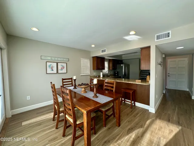 a bedroom with a bed a mirror and a window