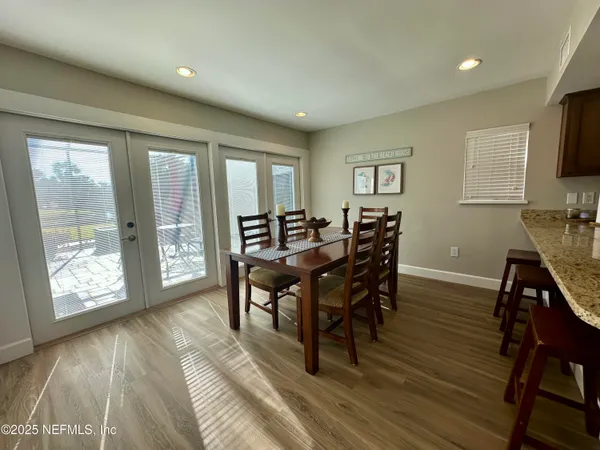 a bedroom with a bed mirror and vanity