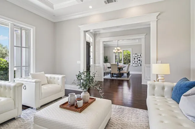 a kitchen with stainless steel appliances a white cabinets and a large window