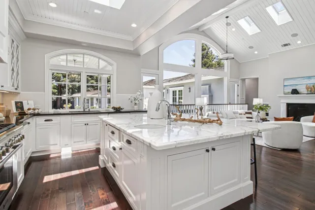 a view of a dining room with furniture a chandelier and wooden floor