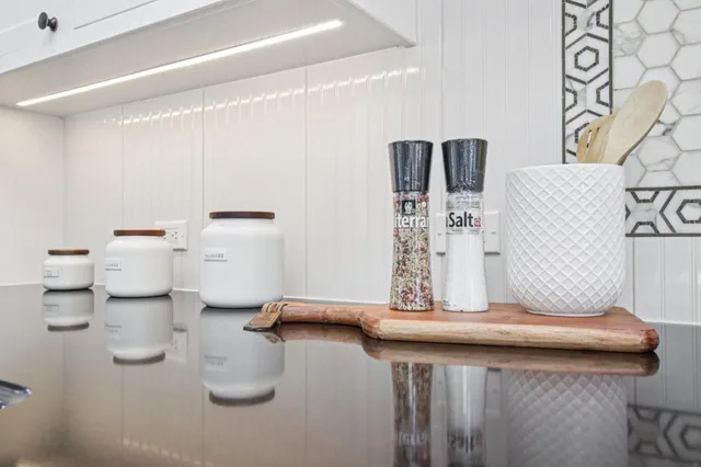 a bathroom with a double vanity sink a mirror and a bathtub