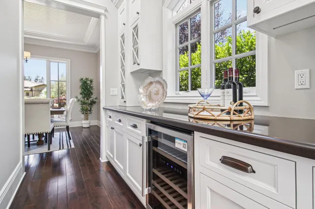walk in closet with white walls and wooden floor