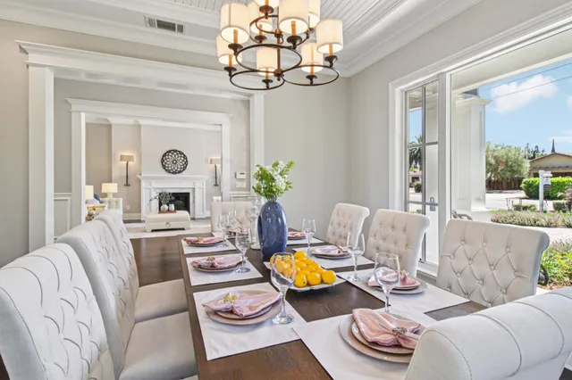 a living room with furniture a table and kitchen chandelier