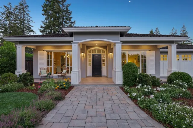 a living room with furniture a fireplace and a large window