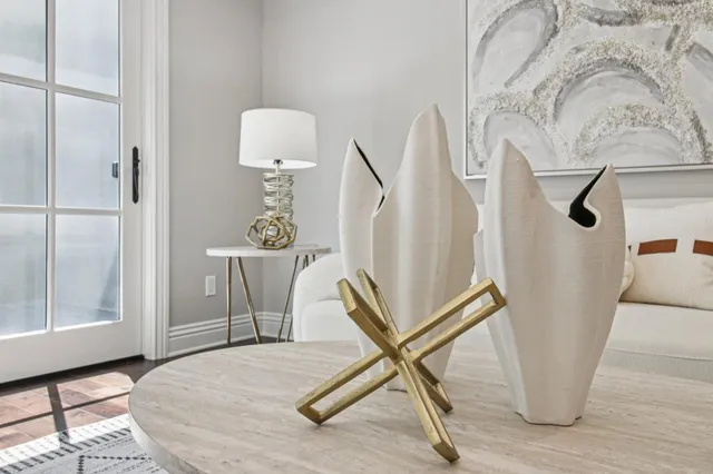 a bedroom with a large bed and a potted plant