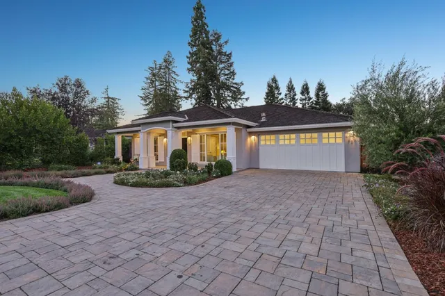 a living room with furniture a chandelier and a large window