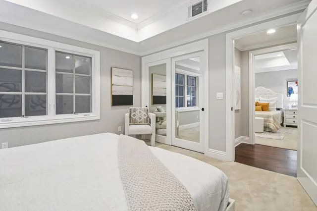 a front view of a house with a garden and trees