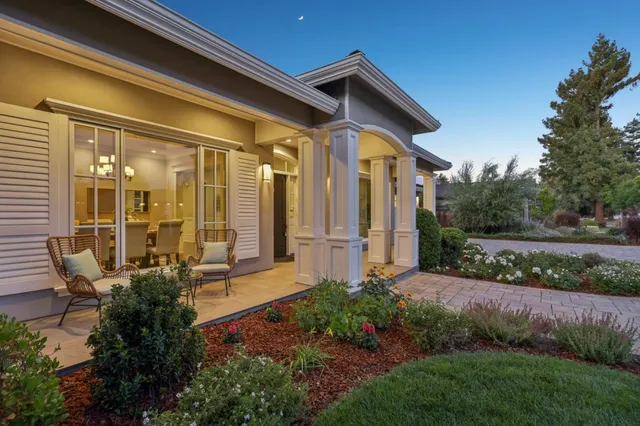 a living room with furniture and a view of kitchen