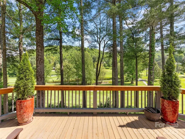a view of a wooden deck and a garden