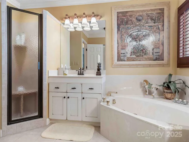 a bathroom with a tub a sink and mirror