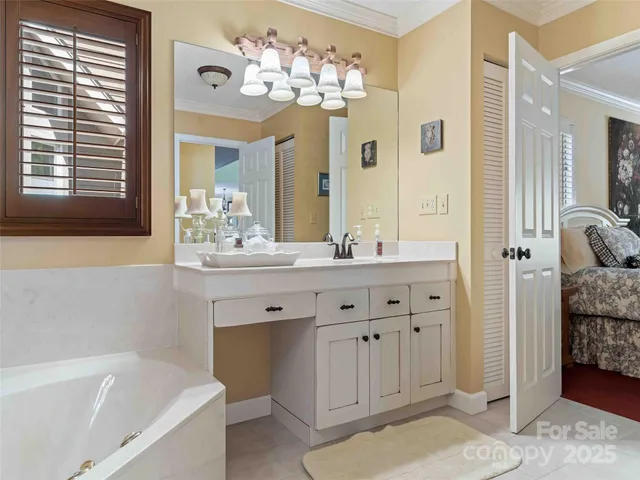 a bathroom with a tub sink and mirror