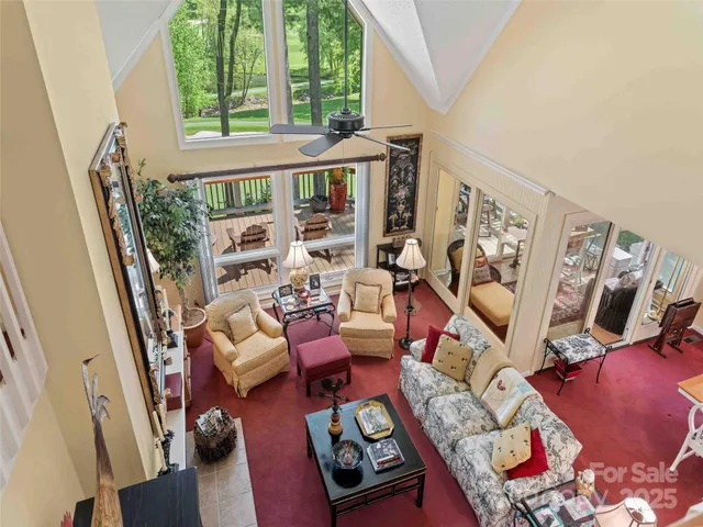 a living room with furniture and a floor to ceiling window