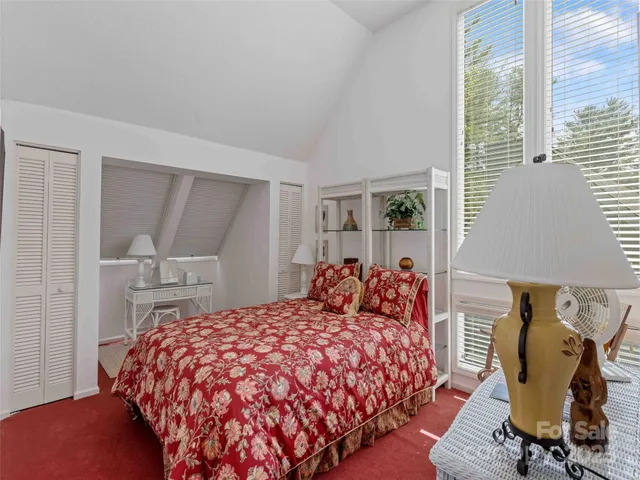 a bedroom with a bed and a chair