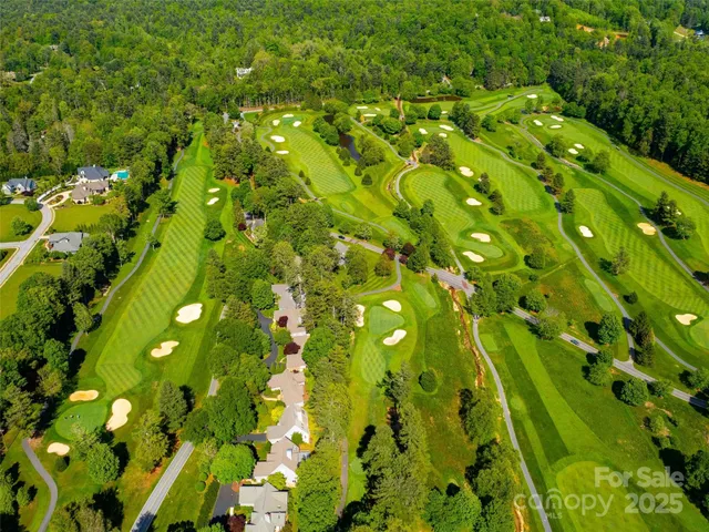 an aerial view of a house with a garden and swimming pool