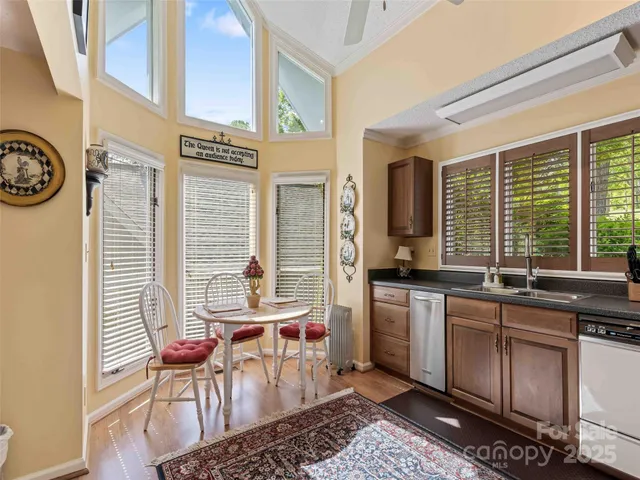 a kitchen with a stove a sink and chairs