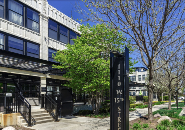 1110 West 15th Street, Unit 113 Chicago, IL 60608 - Photo 1 of 14 a front view of a building with garden