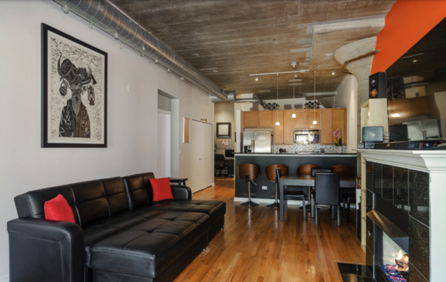 1110 West 15th Street, Unit 113 Chicago, IL 60608 - Photo 3 of 14 a living room with furniture and kitchen view