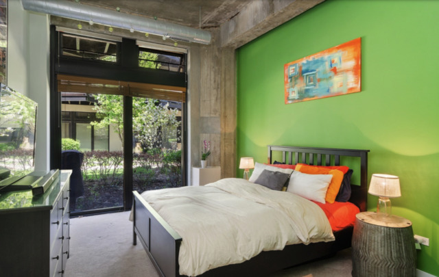 1110 West 15th Street, Unit 113 Chicago, IL 60608 - Photo 5 of 14 a bedroom with a bed and a large window