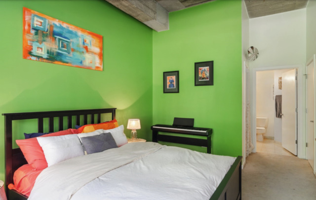 1110 West 15th Street, Unit 113 Chicago, IL 60608 - Photo 7 of 14 a bed room with a bed and a painting on the wall