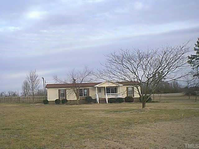 84 Rodeo Drive Zebulon, NC 27597 - Photo 1 of 1 a front view of a house with a yard