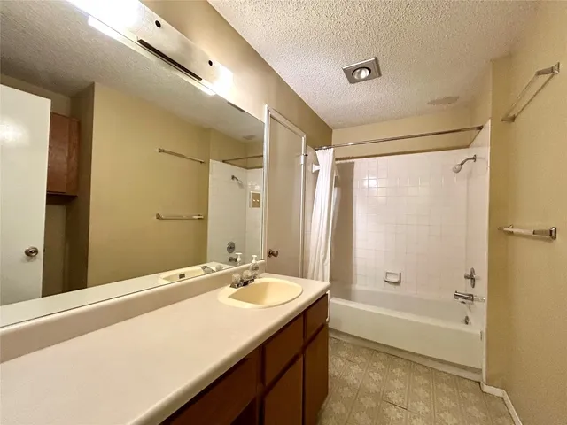 an empty room with closet and windows