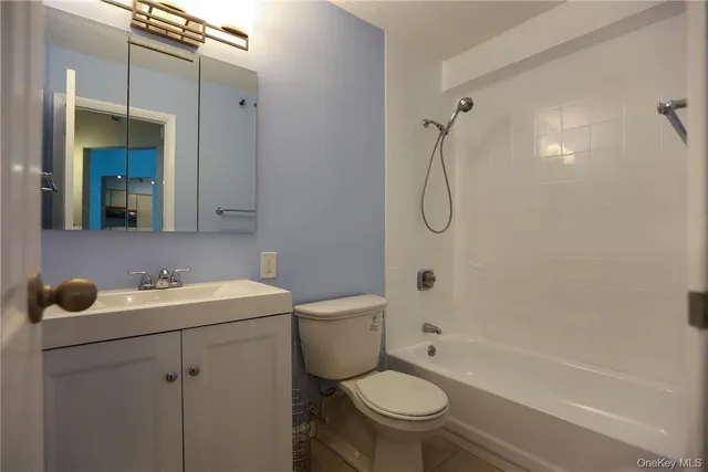 a bathroom with a sink toilet vanity and shower