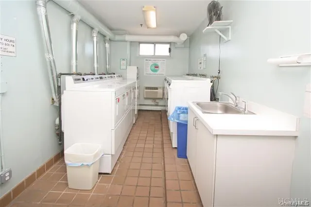 a utility room with a sink a washer and dryer