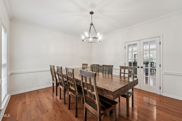 a dining room with furniture window and wooden floor