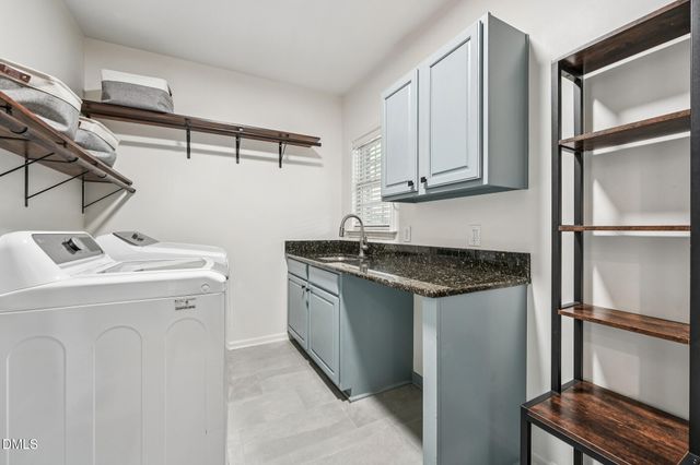 a living room with large windows a rug and a floor to ceiling window