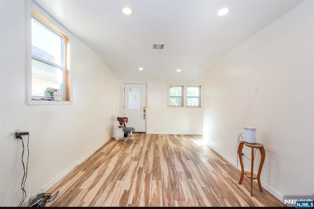 337-379 Ellison Street Paterson, NJ 07501 - Photo 16 of 27 a view of empty room with wooden floor and fan