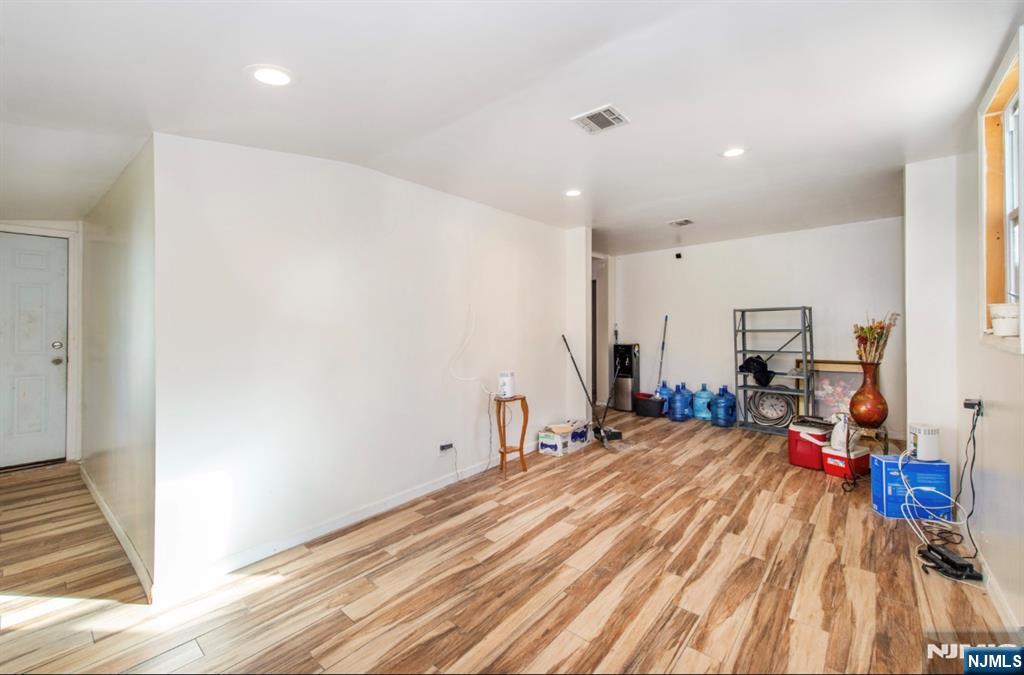 337-379 Ellison Street Paterson, NJ 07501 - Photo 17 of 27 a room with wooden floor and furniture
