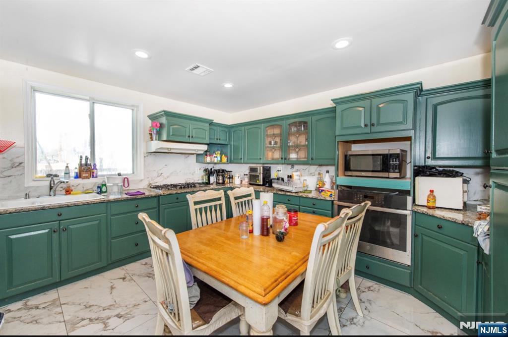 337-379 Ellison Street Paterson, NJ 07501 - Photo 18 of 27 a view of a dining room with furniture and a kitchen