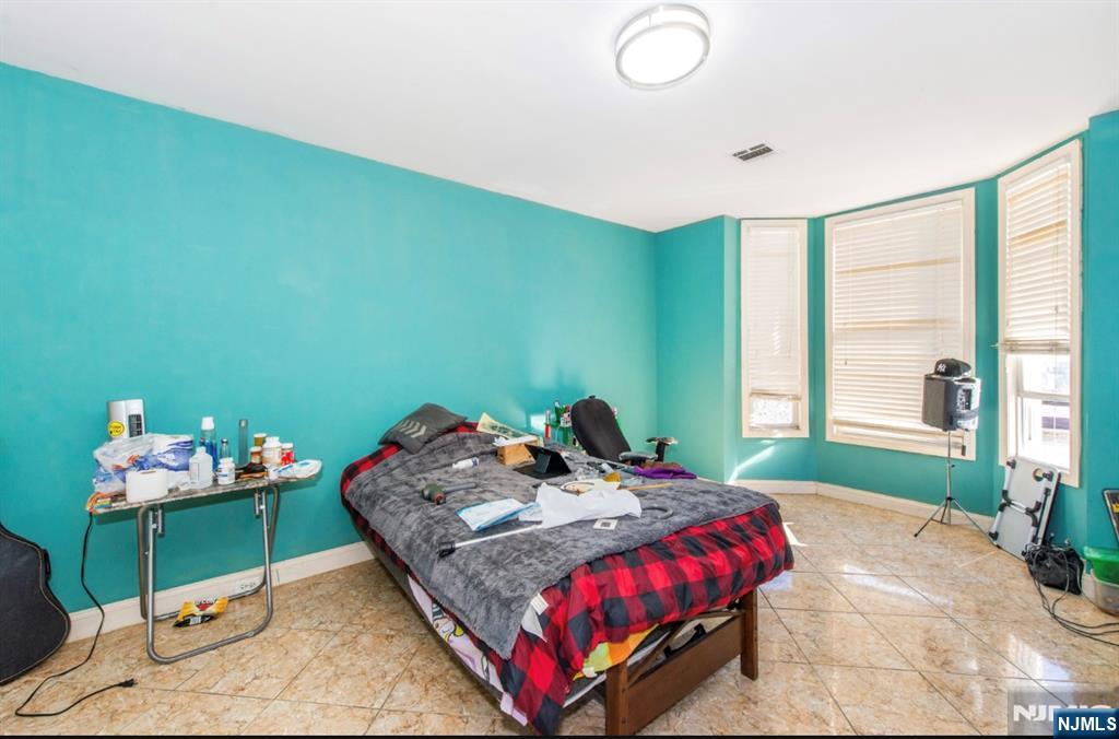337-379 Ellison Street Paterson, NJ 07501 - Photo 22 of 27 a bedroom with a bed and a window
