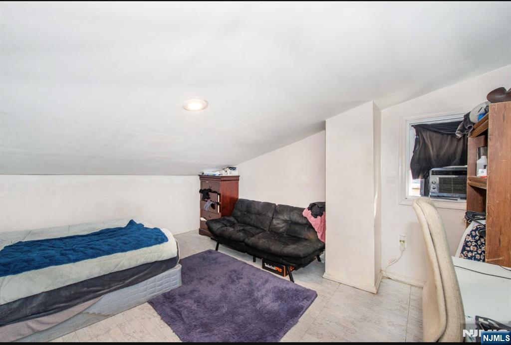 337-379 Ellison Street Paterson, NJ 07501 - Photo 24 of 27 a living room with furniture and a lamp