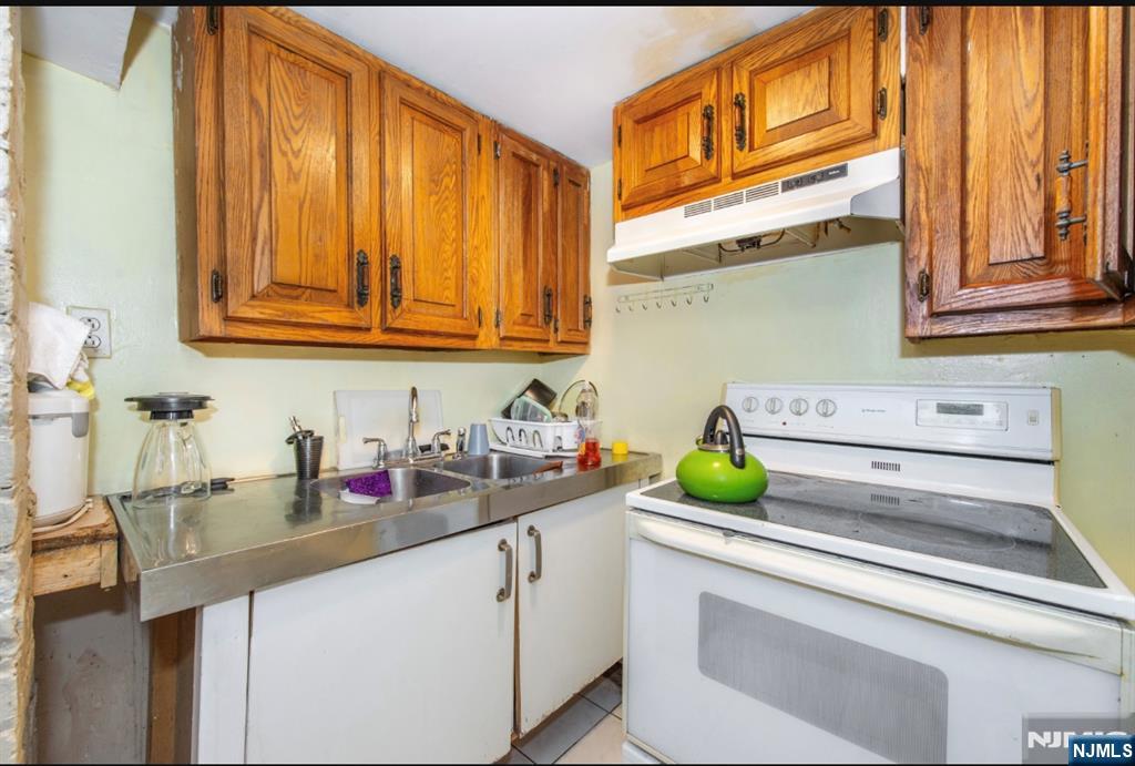 337-379 Ellison Street Paterson, NJ 07501 - Photo 27 of 27 a bathroom with a sink and a mirror