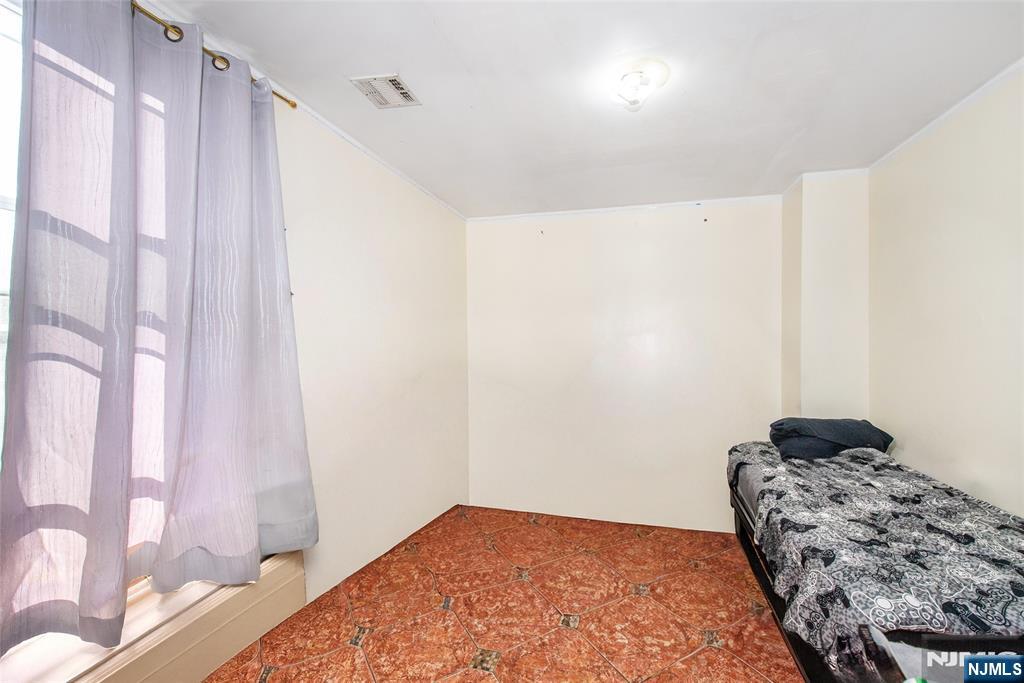 337-379 Ellison Street Paterson, NJ 07501 - Photo 5 of 27 a bedroom with a bed and a window