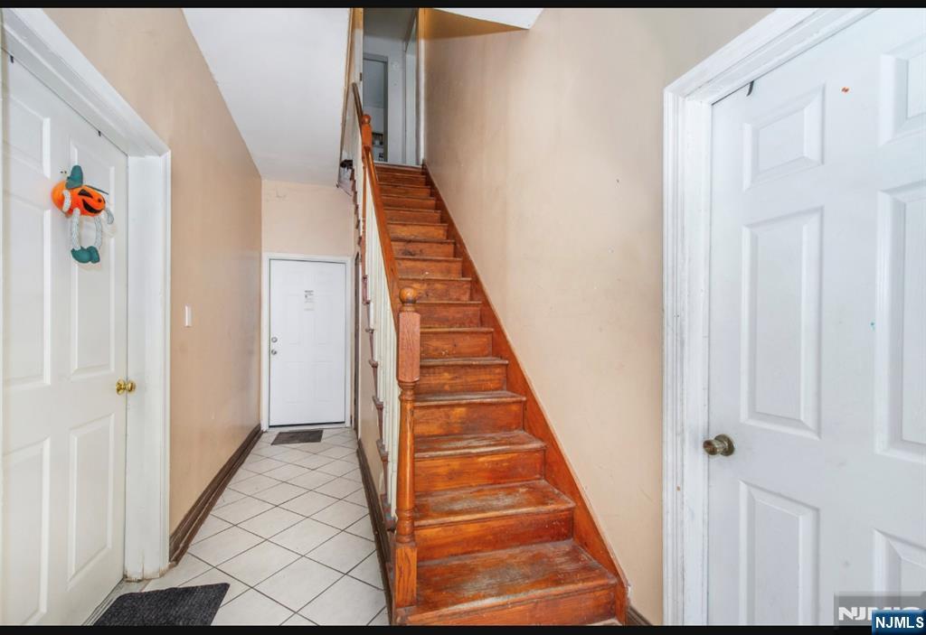 337-379 Ellison Street Paterson, NJ 07501 - Photo 7 of 27 a view of a hallway with wooden floor and staircase
