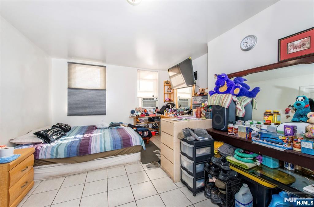 337-379 Ellison Street Paterson, NJ 07501 - Photo 8 of 27 a playing room with furniture and a window