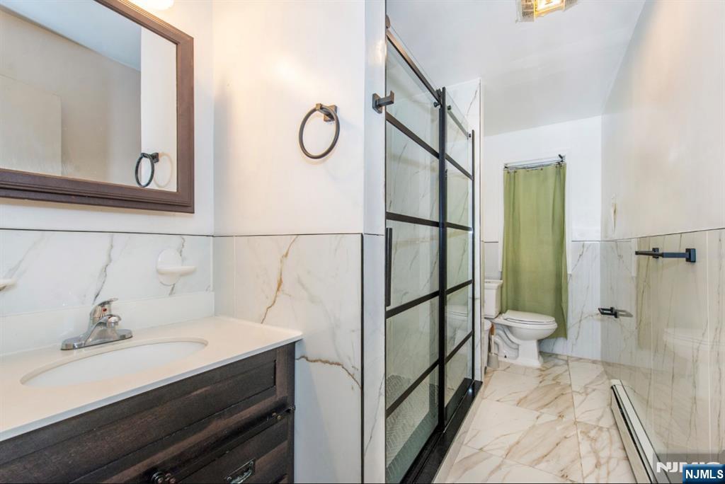 337-379 Ellison Street Paterson, NJ 07501 - Photo 10 of 27 a bathroom with a sink and a mirror