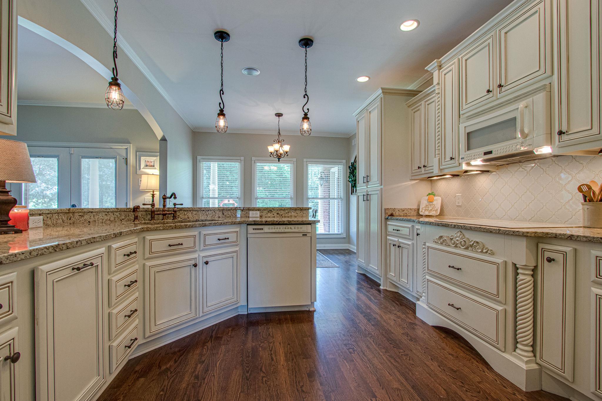 4996 Charles Dorris Road Springfield, TN 37172 - Photo 14 of 29 a large kitchen with granite countertop a stove a sink a center island and wooden floor