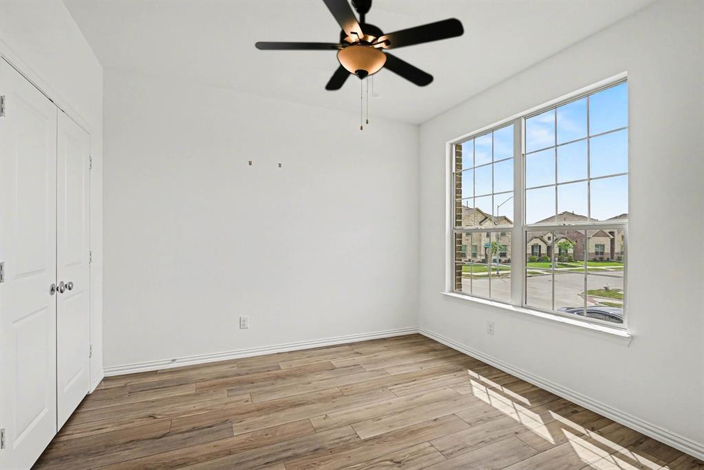 10004 Thornapple Road Fort Worth, TX 76179 - Photo 12 of 39 wooden floor in an empty room with a window