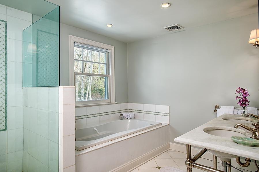 82 Parish Road New Canaan, CT 06840 - Photo 18 of 22 a bathroom with a bathtub and a sink