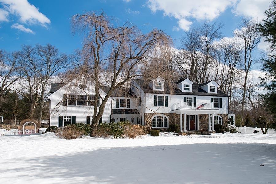 82 Parish Road New Canaan, CT 06840 - Photo 2 of 22 a front view of a building with a yard