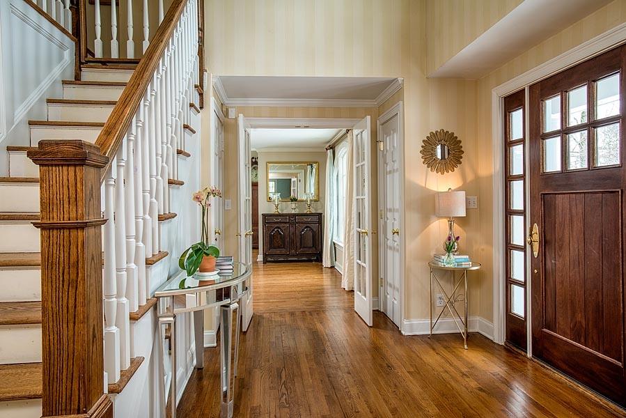 82 Parish Road New Canaan, CT 06840 - Photo 4 of 22 a view of hallway with wooden floor and stairs