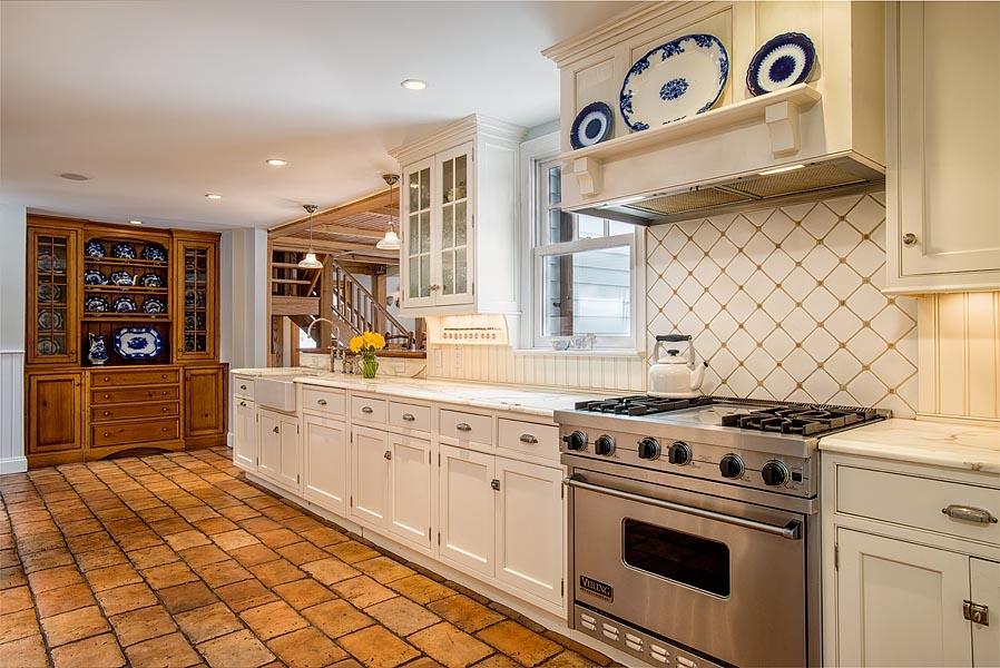 82 Parish Road New Canaan, CT 06840 - Photo 9 of 22 a kitchen with a stove and a white cabinets