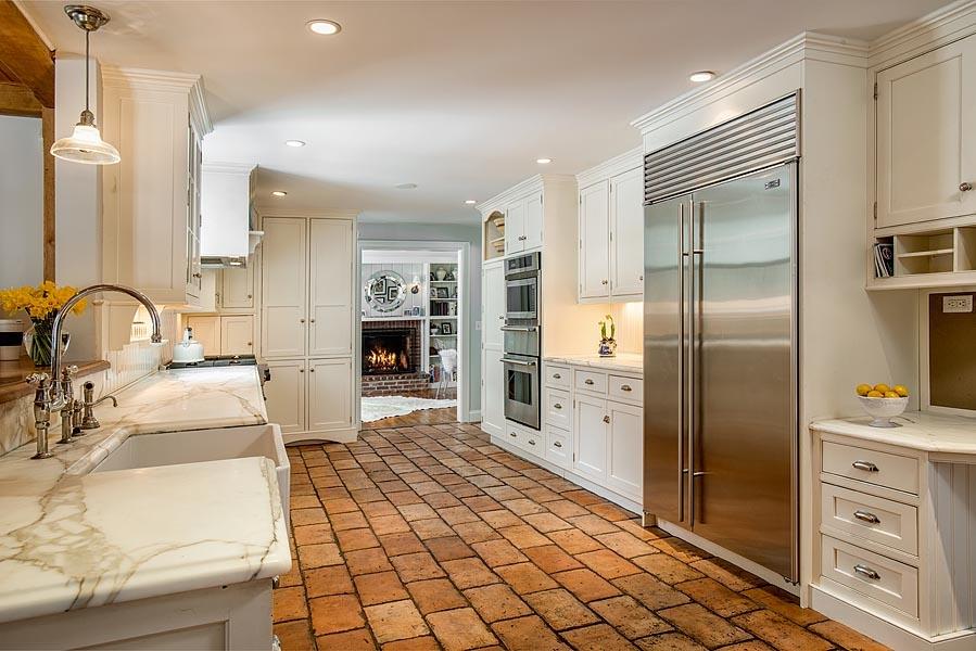 82 Parish Road New Canaan, CT 06840 - Photo 10 of 22 a large kitchen with a refrigerator a sink and cabinets