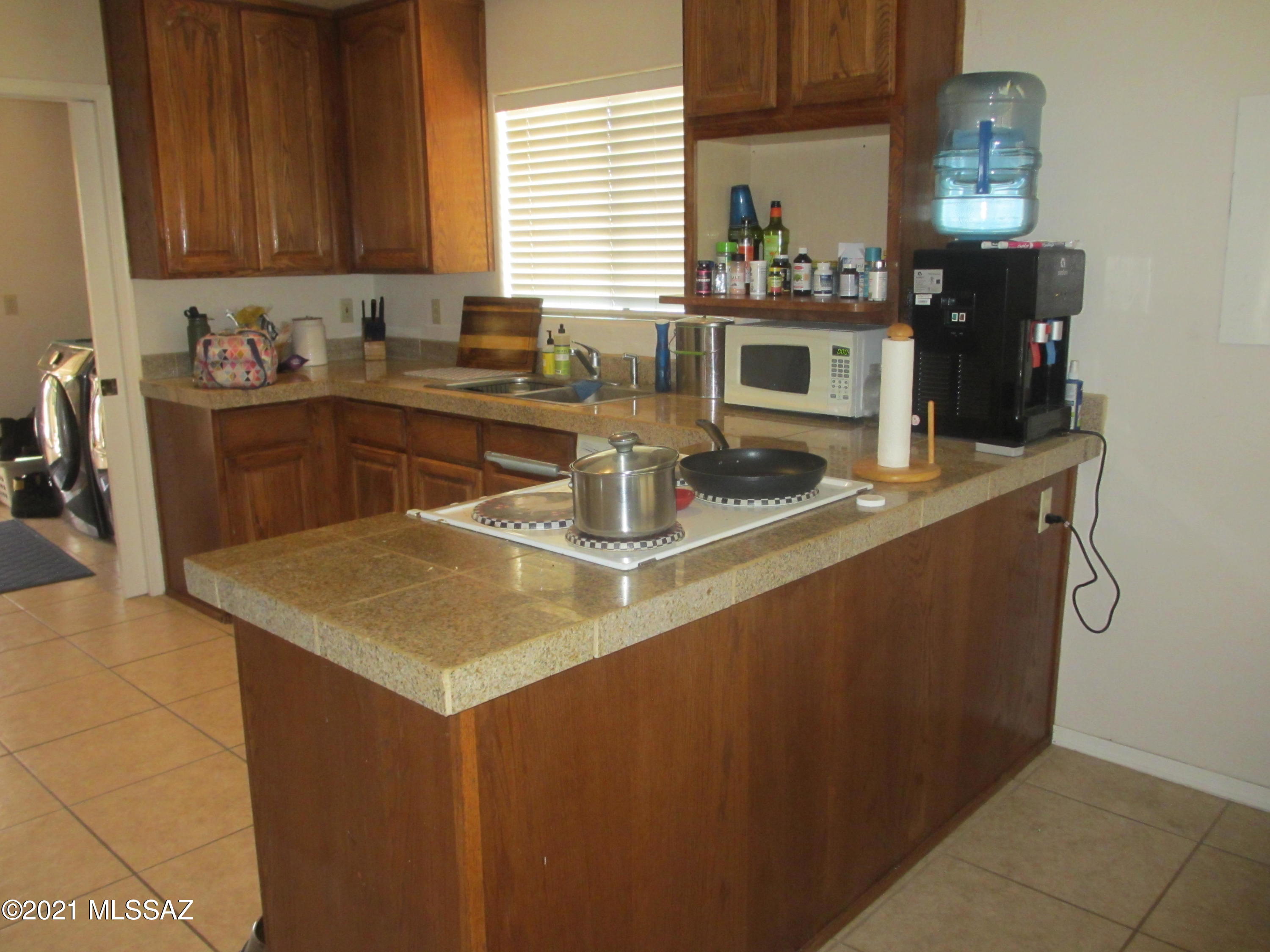 978 Calle Amarillo Rio Rico, AZ 85648 - Photo 20 of 34 a kitchen with a sink and cabinets