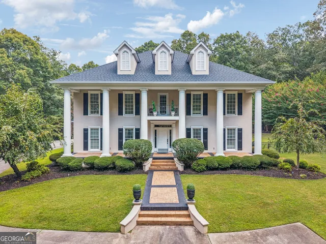 a view of a house with swimming pool and a yard