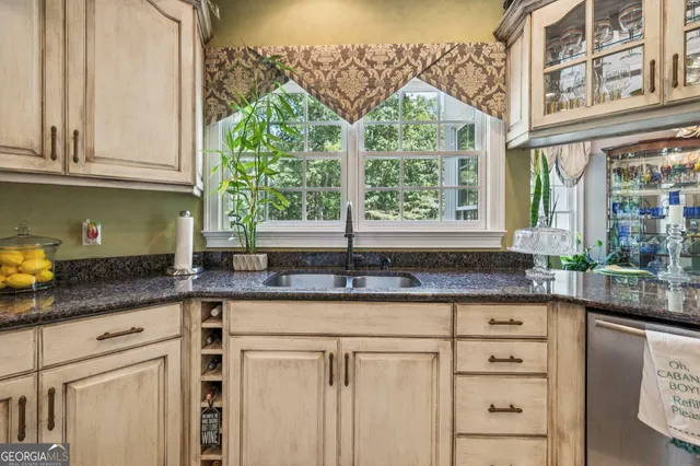 a living room with patio furniture and a flat screen tv